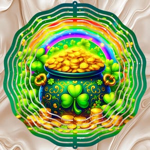 May include: A St. Patrick's Day themed design featuring a pot of gold at the end of a rainbow. The pot is dark blue with gold handles and is surrounded by green shamrocks. The design is set against a green, wavy border.