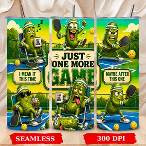 May include: A cylindrical tumbler featuring a vibrant pickleball theme with green cartoon pickles playing on a blue court. The design includes text that reads JUST ONE MORE GAME, I MEAN IT THIS TIME, and MAYBE AFTER THIS ONE, along with a metal straw.