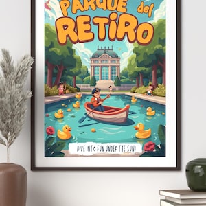 May include: A framed poster with a colourful illustration of Parque del Retiro. The image features a pond with rubber ducks, a person rowing a boat, and the text "DIVE INTO FUN UNDER THE SUN!"
