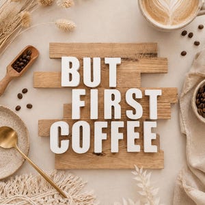Könnte beinhalten: Ein Holzschild mit weißen Buchstaben, die BUT FIRST COFFEE bilden, umgeben von einer Keramiktasse mit Latte Art, einer kleinen Holzschaufel mit Kaffeebohnen, einem goldenen Löffel auf einem gesprenkelten Teller, Trockengräsern und einem beigen Tuch.