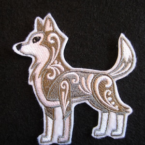 May include: Embroidered iron-on patch of a stylized dog with a brown and white floral design.