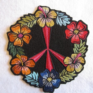 May include: Embroidered peace sign patch with a red peace symbol surrounded by a wreath of colorful hibiscus flowers.
