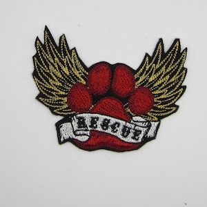 May include: Red paw print with gold wings and a white banner with the text "Forever" in black lettering.