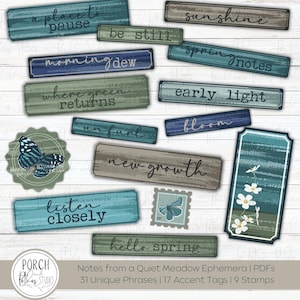 May include: A collection of ephemera with phrases like "a place to pause" and "new growth" on rectangular tags. The tags are in shades of blue, green, and brown, with a distressed wood-like texture. A butterfly graphic and stamp are also included.