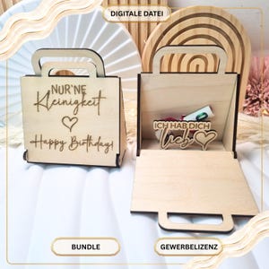 May include: Two light-colored wooden gift boxes shaped like small handbags. The left box features the engraved text "NUR'NE Kleinigkeit" and "Happy Birthday!" with a heart. The right box is open, revealing an engraved "ICH HAB DICH lieb" sign.