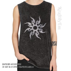 May include: A black sleeveless top featuring a white sunburst design. The garment has a faded, textured look. The text "Kraftilyem on Everything!" and a website address are printed at the bottom. This is a casual wear item.