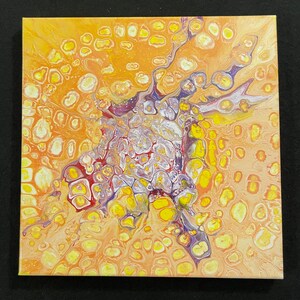May include: Square abstract acrylic painting with a fluid pour technique. The artwork features a vibrant color palette of yellow, orange, purple, and white. The design has a cell-like pattern with a central burst of color and a textured appearance.