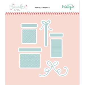 May include: A set of die-cut paper gift box shapes in light blue and white, with various patterns, including stripes and polka dots. The set includes bows and the text "8 PIEZAS / TROQUELES" and "diciembre". The background is a soft pink.
