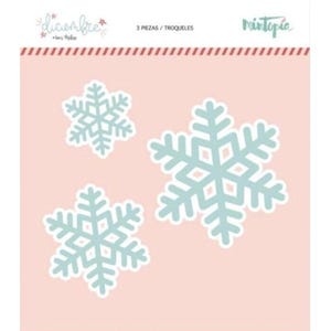 May include: Three snowflake cutouts in varying sizes, each with a light blue design and white border, are displayed on a pink background. The text "diciembre" and "3 PIEZAS / TROQUELES" are visible. The brand name "Mintopia" is also present.