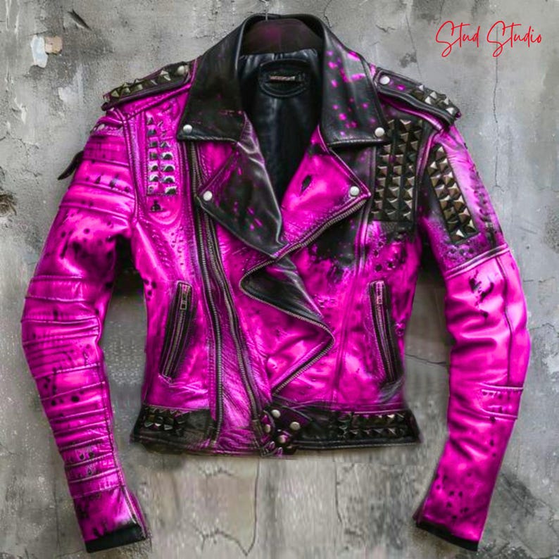 May include: A hot pink leather jacket with black accents and silver studs. The jacket features a classic biker style with a notched collar, asymmetrical zipper, and multiple pockets. The sleeves have quilted detailing, and the shoulders are adorned with pyramid studs.