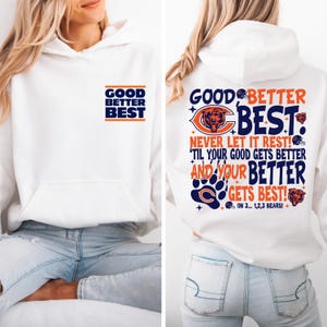 May include: White hoodie with a front pocket and a hood. The front of the hoodie has the text "GOOD BETTER BEST" in navy blue and orange. The back of the hoodie has the text "GOOD BETTER BEST" with a bear logo and the text "NEVER LET IT REST!"