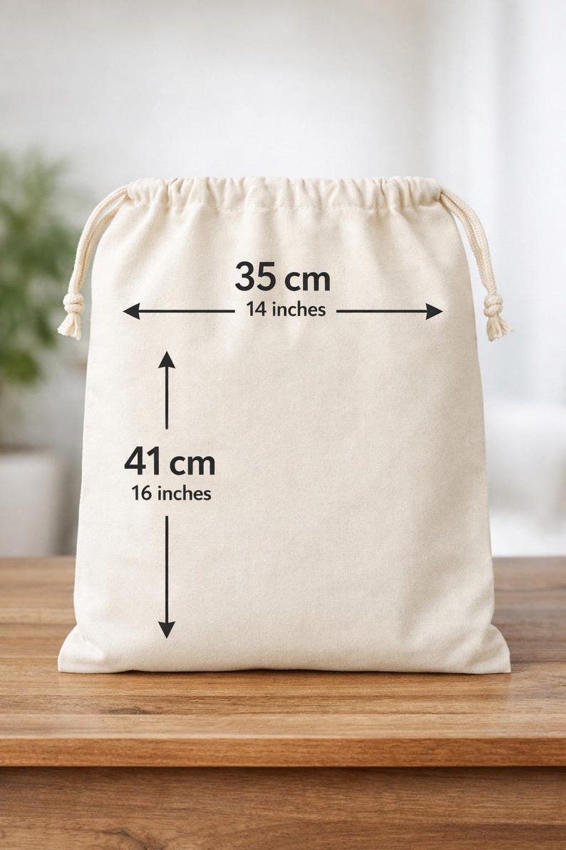 May include: A beige drawstring bag, 14 inches wide and 16 inches tall, with measurements in both inches and centimeters. The bag is made of a soft, natural fabric and sits on a wooden surface.