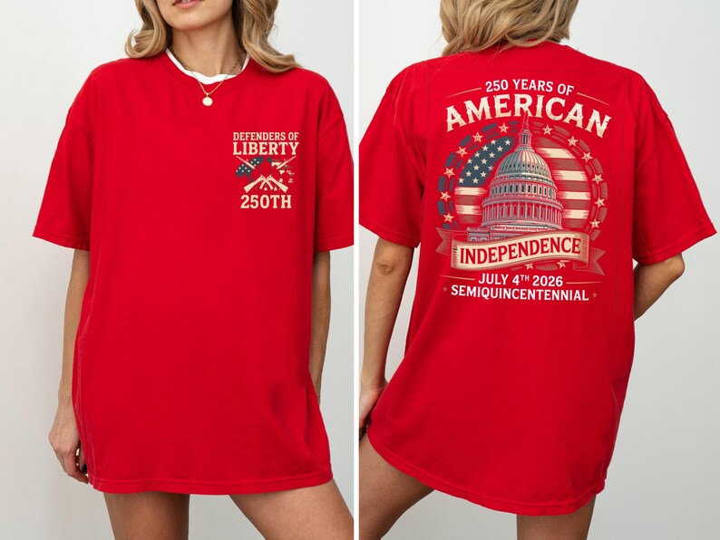 May include: Red t-shirt with patriotic graphics. The front has "Defenders of Liberty" with crossed rifles and "250th". The back shows "250 Years of American Independence" with the Capitol building, American flag, and the date "July 4th 2026".