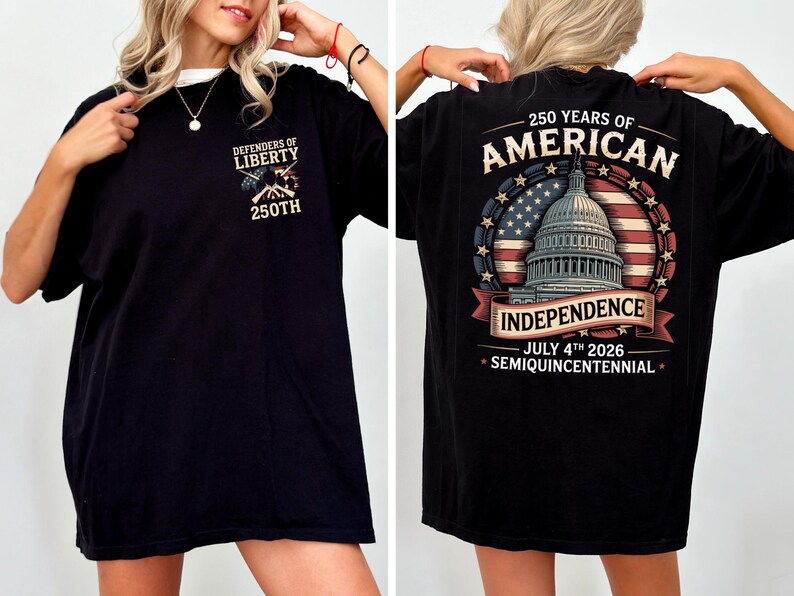 May include: Black t-shirt with a white collar. The front has the text "Defenders of Liberty" and "250th" with an emblem. The back features a design celebrating 250 years of American Independence, including the Capitol building and the date July 4th, 2026.
