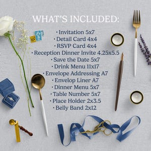 May include: An assortment of wedding stationery and accessories, including invitations, RSVP cards, and menus. The image features a gold fork and spoon, blue ring boxes, and floral arrangements, all arranged on a light gray surface.