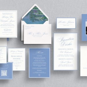 May include: An assortment of wedding stationery in shades of blue and white, including invitations, RSVP cards, menus, and table cards. The invitation suite features elegant calligraphy and a photo of the couple.
