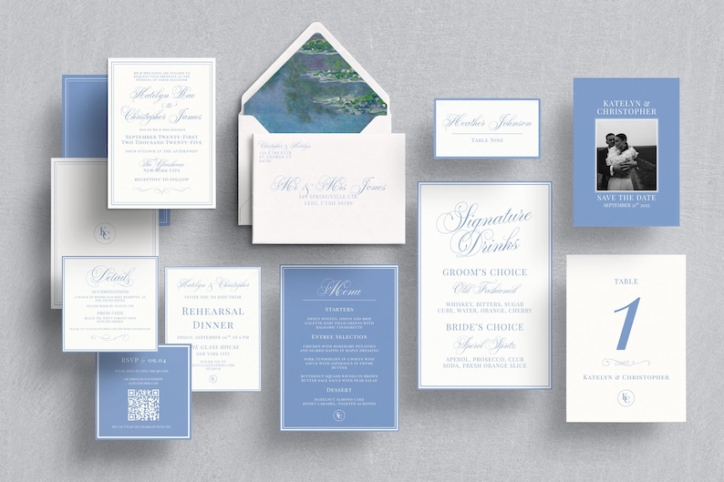 May include: An assortment of wedding stationery in shades of blue and white, including invitations, RSVP cards, menus, and table cards. The invitation suite features elegant calligraphy and a photo of the couple.