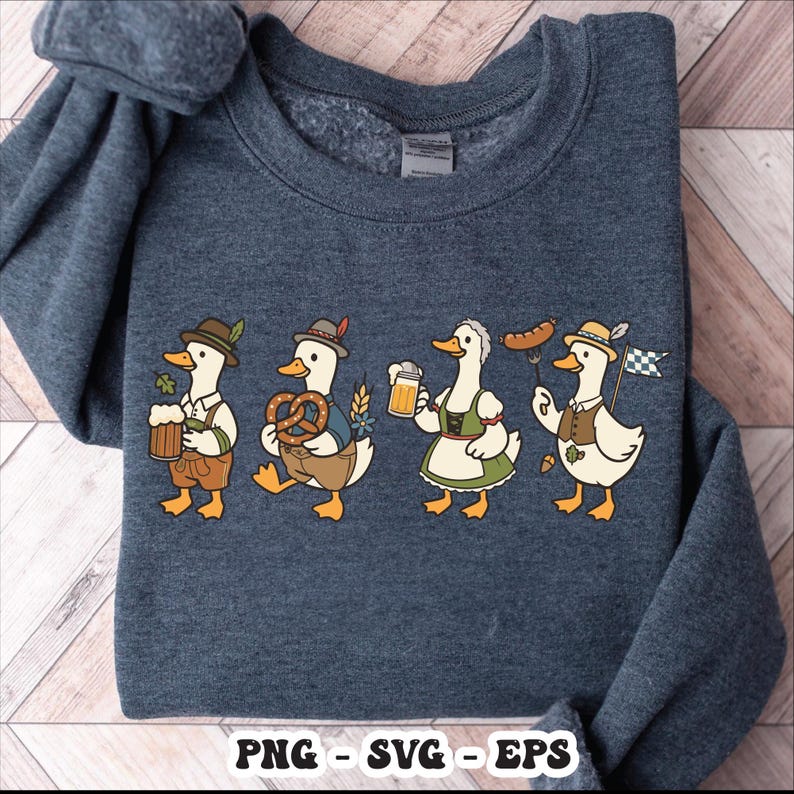 May include: A navy blue sweatshirt featuring a whimsical illustration of four cartoon ducks dressed in traditional Bavarian attire. Each duck is holding items like beer, pretzels, and a sausage, with the text "PNG - SVG - EPS" at the bottom.