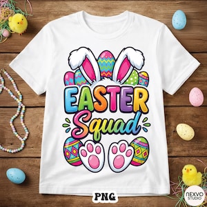 May include: White t-shirt with a colorful "EASTER Squad" graphic. The design includes bunny ears, Easter eggs, and paw prints. The shirt is made of a soft material and is perfect for Easter celebrations.