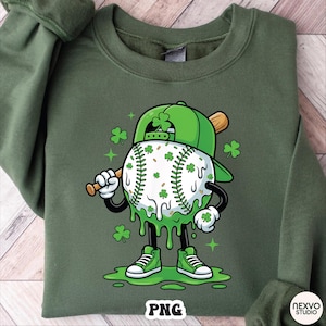May include: Green sweatshirt with a St. Patrick's Day baseball character. The baseball is white with green shamrocks and dripping green goo. The character wears a green cap, shoes, and holds a bat. The word "PNG" is at the bottom.