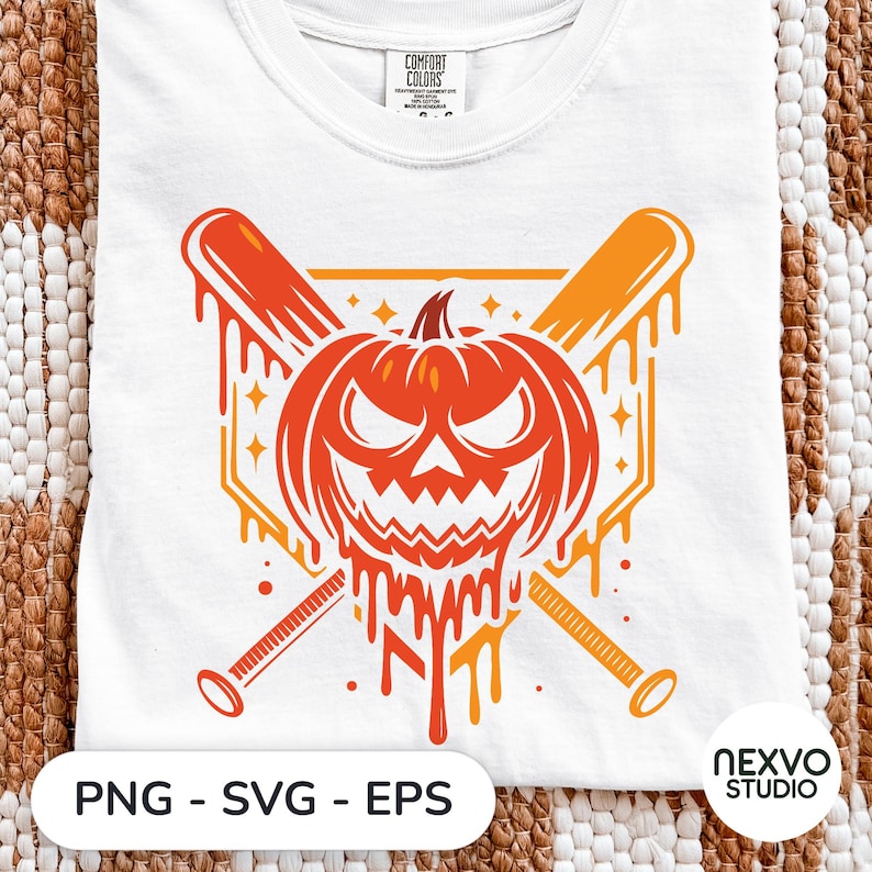 May include: A white t-shirt featuring a graphic of a carved pumpkin with a menacing expression, positioned in front of two crossed baseball bats. The design includes dripping orange paint effects and a home plate shape in the background.