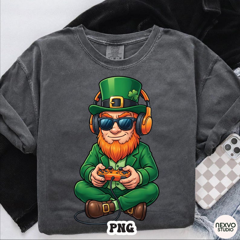 May include: Dark gray t-shirt featuring a cartoon leprechaun wearing a green suit, hat, and sunglasses, with orange headphones. The leprechaun is holding a game controller. The word "PNG" is at the bottom.