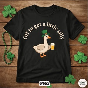 May include: Black t-shirt featuring a cartoon goose wearing a green hat and holding a beer. The text "Off to get a little silly" arches above the goose. The design is set against a wooden background with shamrock decorations.
