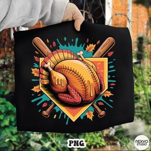 May include: Black graphic featuring a roasted turkey designed as a baseball. The turkey is inside a baseball diamond with crossed baseball bats. Autumn leaves and teal paint splatters surround the design. The text "PNG" is at the bottom.