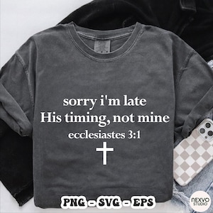 May include: Charcoal grey long-sleeved shirt featuring the text "sorry i'm late His timing, not mine ecclesiastes 3:1" and a white cross. The shirt also has "PNG - SVG - EPS" text at the bottom.