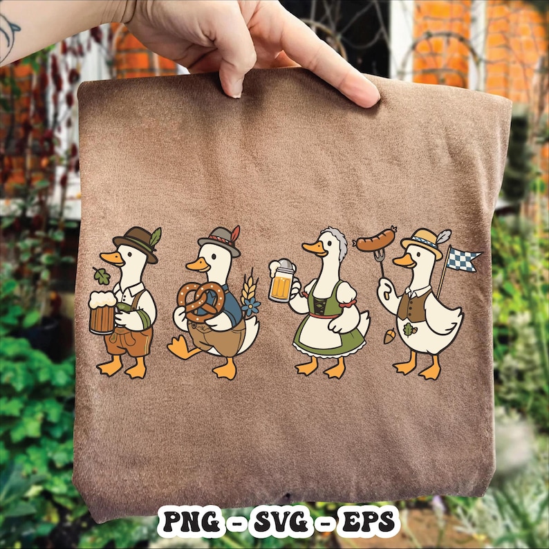 May include: A brown fabric item featuring a cartoon design of four ducks dressed in traditional Bavarian attire. Each duck is holding items like beer, pretzels, and sausages. The bottom of the item has the text "PNG - SVG - EPS".