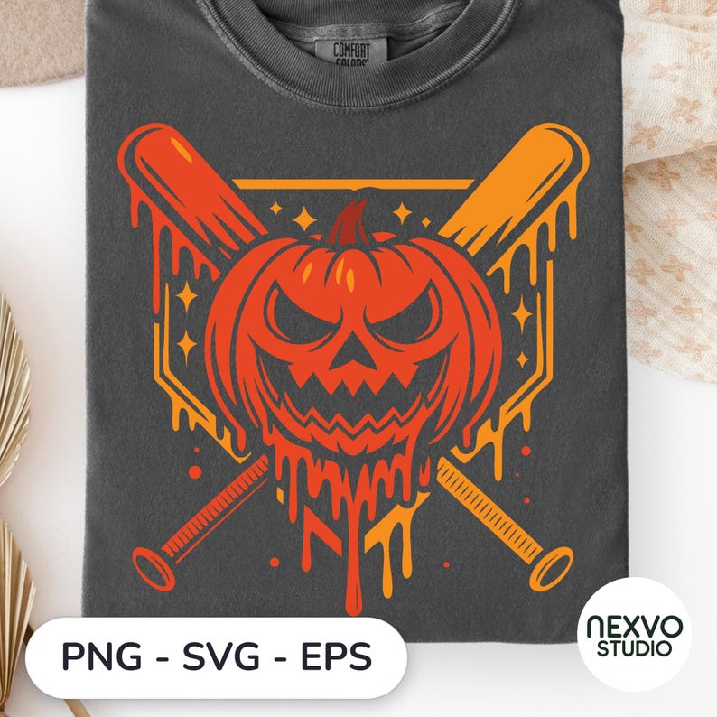 May include: A charcoal gray t-shirt featuring a graphic print of a melting orange jack-o'-lantern centered over two crossed baseball bats. The design includes small star accents and a geometric border. The shirt has a crew neckline and a visible label.