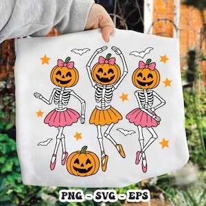 May include: White tote bag featuring a Halloween design. The design includes three skeleton figures with pumpkin heads, wearing tutus and ballet shoes. Bats and stars surround the figures. A pumpkin is at the bottom. The text "PNG - SVG - EPS" is at the bottom.