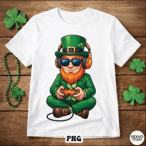 May include: White t-shirt featuring a cartoon leprechaun wearing sunglasses and headphones, holding a video game controller. The leprechaun is dressed in green and orange, with a red beard. The design is set against a wooden background.