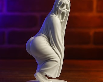 May include: A white sculpture of the Ghostface character from the Scream horror film franchise. The figure is in a squatting pose, with the iconic mask and robe. The sculpture is on a white circular base, set against a brick wall.