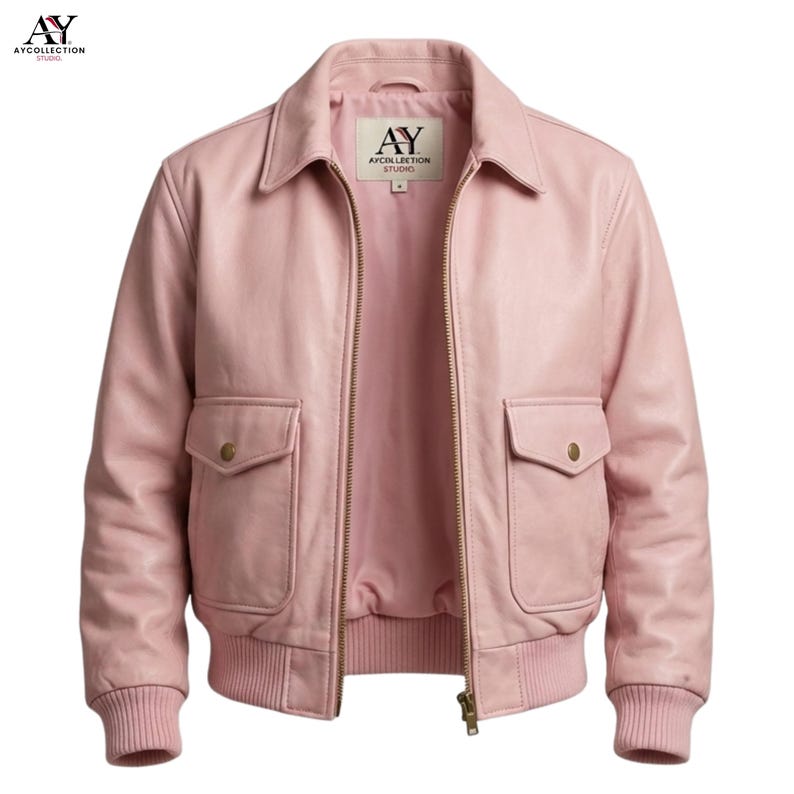 May include: A light pink leather jacket with a collared neckline, two front pockets, and a ribbed hem and cuffs. The jacket has a zipper closure and a label inside the collar that reads "AY COLLECTION STUDIO".