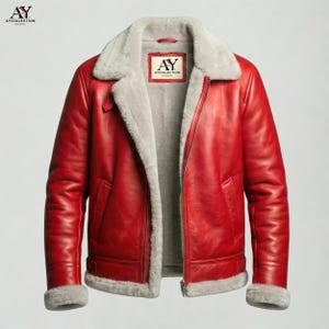 May include: A red leather jacket with a gray shearling collar and lining. The jacket has a zip closure, a buckled strap at the waist, and the text "AY COLLECTION STUDIO" on a tag.