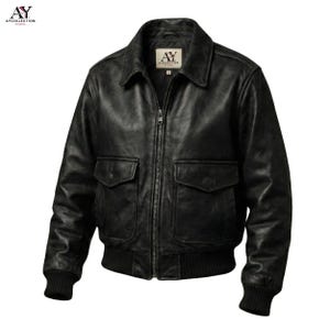 May include: A black leather jacket with a zip-up front, two front pockets, and a ribbed hem and cuffs. The jacket has a collared neckline and a logo patch on the chest. The jacket is a classic bomber style.