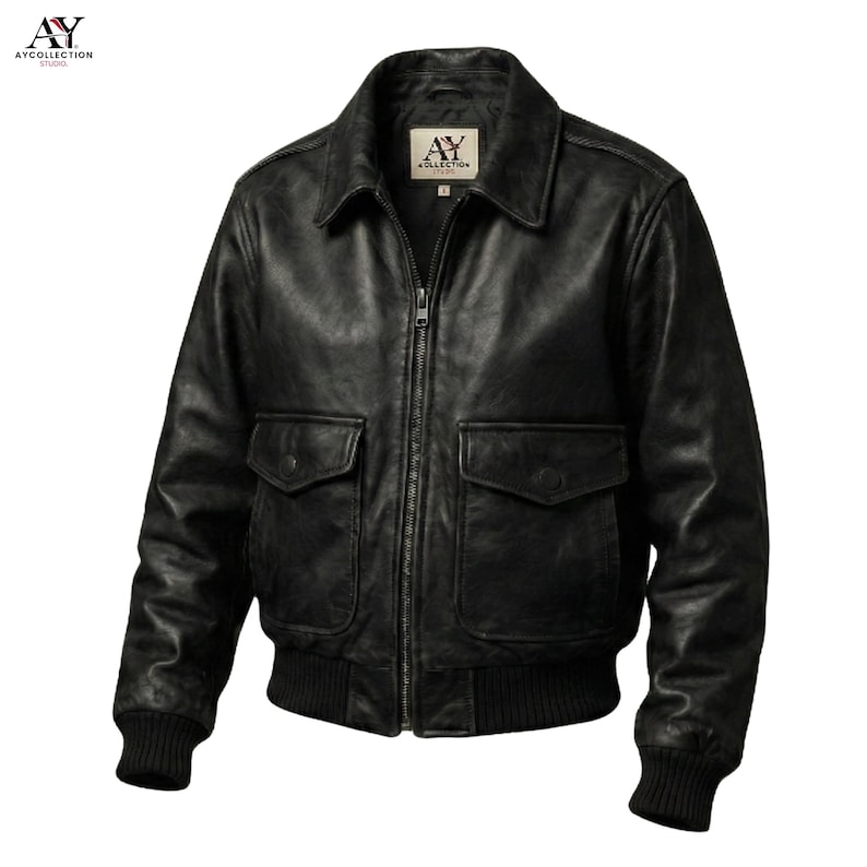 May include: A black leather jacket with a zip-up front, two front pockets, and a ribbed hem and cuffs. The jacket has a collared neckline and a logo patch on the chest. The jacket is a classic bomber style.