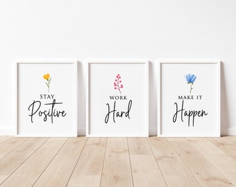 May include: Three white framed prints with motivational quotes and watercolor floral illustrations. The first print says "Stay Positive" with a yellow flower. The second print says "Work Hard" with a pink flower. The third print says "Make It Happen" with a blue flower.