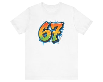 May include: White t-shirt featuring a colorful graffiti-style design of the number 67. The numbers are outlined in blue with a gradient of orange, yellow, and green. Blue paint drips and splatters surround the numbers.