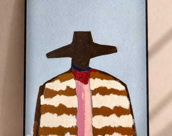 May include: A framed wall art print featuring a stylized figure wearing a wide-brimmed dark brown hat. The figure is dressed in a garment with horizontal brown and white stripes, a central vertical pink stripe, and a small red accent at the neck.