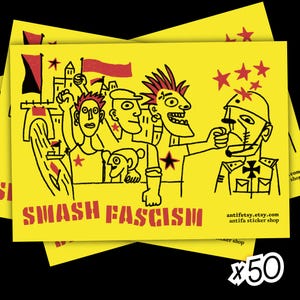 Könnte beinhalten: Gelber Aufkleber mit einer schwarz-roten Illustration von Cartoonfiguren, die einen Soldaten konfrontieren. Der Text "SMASH FASCISM" ist rot. Enthält die Website antifetsy.etsy.com und "antifa sticker shop".