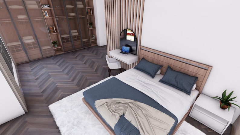 Puede incluir: Un dormitorio moderno con una cama con estructura de madera, edred&oacute;n y almohadas azules. Tambi&eacute;n se ven una alfombra blanca y un armario de madera. Un peque&ntilde;o escritorio con un port&aacute;til y una silla est&aacute; junto a la cama.