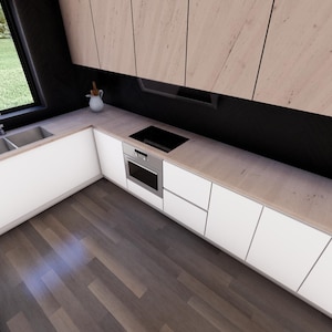 Puede incluir: Una cocina moderna con gabinetes blancos, un fregadero de acero inoxidable y un horno empotrado. La encimera es de madera clara y hay una peque&ntilde;a planta en maceta en el mostrador.