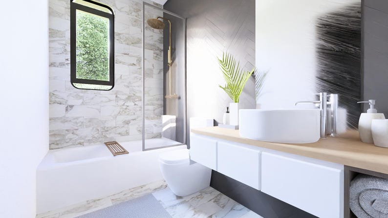 May include: Contemporary bathroom interior with a white suite, including a bathtub, toilet, and basin. The shower has a glass screen and gold fittings. A window provides a view of foliage. The vanity unit has white cupboards and a wooden surface.