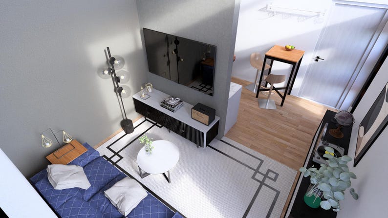 May include: An overhead view of a modern living room with a blue sofa, white rug, and a black and white entertainment center. A large flat-screen TV is mounted on the wall above the entertainment center. A small table and chairs are in the background.