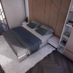 Puede incluir: Un dormitorio moderno con una cama blanca, ropa de cama gris y azul, y almohadas verdes. Una alfombra blanca y esponjosa cubre el suelo. Se ven una puerta de madera y un armario empotrado con estanter&iacute;as.