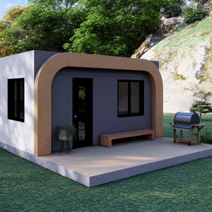 May include: A modern, small house with a white exterior and a gray roof. The house has black windows and a wooden trim. A small patio with a bench and a grill are in front of the house. The house is surrounded by green grass and trees.