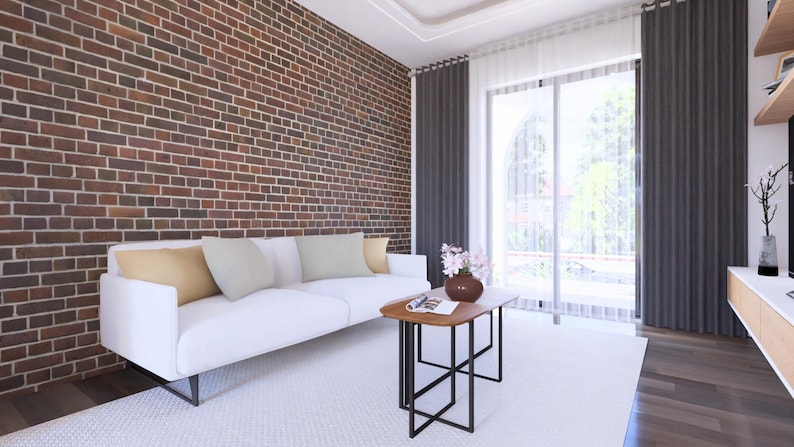 May include: A modern living room with a white sofa, pillows, and a wooden coffee table with a black metal frame. The room features a brick wall, dark gray curtains, and a large window with natural light.