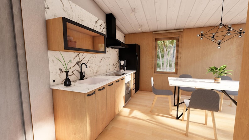 May include: Interior view of a contemporary kitchen featuring light wood cabinets, a white countertop, and a black extractor fan. A black vase and tap are visible. A dining area with a white table and grey chairs is in the background.